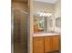 Bathroom featuring a glass shower stall, decorative lighting and spacious vanity at 16729 Tall Grass Ln, Clermont, FL 34711