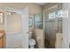 Bathroom with toilet and glass shower, and doorway leading to bedroom with ceiling fan at 16729 Tall Grass Ln, Clermont, FL 34711