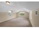 Finished carpeted attic bonus room featuring dual dormer windows letting in natural light at 16729 Tall Grass Ln, Clermont, FL 34711