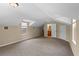 Finished attic bonus room featuring carpet and dormer windows plus bathroom access at 16729 Tall Grass Ln, Clermont, FL 34711