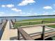 A community pier overlooking a lake offers an idyllic spot to soak in nature's beauty, with calming water views at 16729 Tall Grass Ln, Clermont, FL 34711