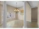 Elegant dining room featuring decorative columns, chandelier, and neutral tile floors at 16729 Tall Grass Ln, Clermont, FL 34711
