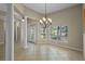 Spacious dining room with plenty of natural light, tile flooring, and views of the outdoors at 16729 Tall Grass Ln, Clermont, FL 34711