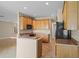Open concept kitchen features wood cabinets, speckled countertops, and tile flooring at 16729 Tall Grass Ln, Clermont, FL 34711