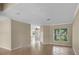 Bright living room with tile flooring, neutral walls, and an open layout at 16729 Tall Grass Ln, Clermont, FL 34711