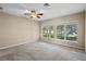 Spacious main bedroom features large windows offering serene lake views and ample natural light at 16729 Tall Grass Ln, Clermont, FL 34711