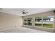 Spacious main bedroom features large windows offering serene lake views and ample natural light at 16729 Tall Grass Ln, Clermont, FL 34711
