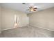 Spacious main bedroom with carpet flooring, a ceiling fan, and en suite bathroom entrance at 16729 Tall Grass Ln, Clermont, FL 34711