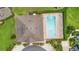 Overhead view of a community pool featuring lounge chairs and lush landscaping around the pool deck at 17404 Chateau Pine Way, Clermont, FL 34711