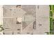 Aerial view of roofs showcases the layout of a residential area with a private patio visible at 17404 Chateau Pine Way, Clermont, FL 34711
