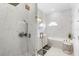 Bright bathroom featuring a glass shower and a double sink vanity with gold hardware and marble at 17404 Chateau Pine Way, Clermont, FL 34711