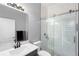 Modern bathroom features subway tile shower with glass door, sleek vanity, and neutral color palette at 17404 Chateau Pine Way, Clermont, FL 34711