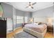 Bedroom with plush bed, bay window, and stylish mirror features natural light and cozy atmosphere at 17404 Chateau Pine Way, Clermont, FL 34711
