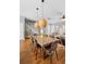 Dining room with hardwood floors, pendant lighting, stairs, and access to living area at 17404 Chateau Pine Way, Clermont, FL 34711