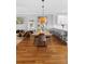 Modern dining area features a large wooden table, stylish seating and hardwood floors at 17404 Chateau Pine Way, Clermont, FL 34711