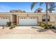Charming home exterior featuring a two-car garage and well-maintained landscaping at 17404 Chateau Pine Way, Clermont, FL 34711