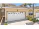 Attached garage offers convenience with decorative windows and well-maintained landscaping at 17404 Chateau Pine Way, Clermont, FL 34711