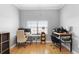 Bright home office with hardwood floors features two desk areas and large window for natural light at 17404 Chateau Pine Way, Clermont, FL 34711