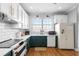 Bright kitchen features white subway tile, modern appliances, and vibrant green cabinetry at 17404 Chateau Pine Way, Clermont, FL 34711