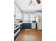 Renovated kitchen with hardwood floors and stainless steel appliances at 17404 Chateau Pine Way, Clermont, FL 34711