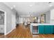 Open living space features an island with wine cooler and hardwood style floors at 17404 Chateau Pine Way, Clermont, FL 34711