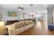 Open-concept living room flows into kitchen with hardwood floors and modern decor at 17404 Chateau Pine Way, Clermont, FL 34711