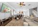Spacious living area offering an open concept with hardwood floors and a ceiling fan at 17404 Chateau Pine Way, Clermont, FL 34711