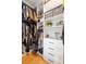 Spacious walk-in closet with custom shelving, drawers, and hanging space for organized storage at 17404 Chateau Pine Way, Clermont, FL 34711