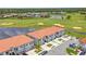 Aerial view of residential townhomes near a golf course and pond at 2041 Greenbriar Ter, Davenport, FL 33837