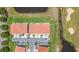 Aerial view of a townhome complex with a pond and golf course nearby at 2041 Greenbriar Ter, Davenport, FL 33837