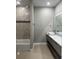 Bright bathroom featuring a shower-tub with a marble surround and a sleek vanity at 2041 Greenbriar Ter, Davenport, FL 33837