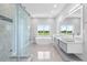 Well-lit bathroom features walk-in shower, soaking tub, and dual sink vanity at 2041 Greenbriar Ter, Davenport, FL 33837
