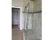Contemporary bathroom featuring a glass-enclosed shower with marble tiling and an interior door at 2041 Greenbriar Ter, Davenport, FL 33837