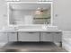 Modern bathroom features dual sinks, a large mirror, and a glass walk-in shower at 2041 Greenbriar Ter, Davenport, FL 33837