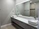 Bathroom with modern double vanity and quartz counters at 2041 Greenbriar Ter, Davenport, FL 33837