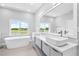 Bathroom features a soaking tub, dual sinks, and luxury plumbing fixtures at 2041 Greenbriar Ter, Davenport, FL 33837