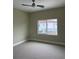Bedroom with neutral carpet and a window offering neighborhood views at 2041 Greenbriar Ter, Davenport, FL 33837