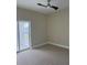 Cozy bedroom featuring a ceiling fan and a sliding glass door that opens onto a balcony at 2041 Greenbriar Ter, Davenport, FL 33837