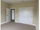 Bright bedroom featuring a closet with sliding doors and neutral carpeting at 2041 Greenbriar Ter, Davenport, FL 33837