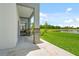 Inviting covered patio overlooking a lush lawn and serene lake view at 2041 Greenbriar Ter, Davenport, FL 33837