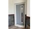 Contemporary gray front door with a vertical window panel and digital lock system at 2041 Greenbriar Ter, Davenport, FL 33837