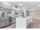 Modern kitchen featuring stainless steel appliances, an island, and plenty of cabinet space at 2041 Greenbriar Ter, Davenport, FL 33837