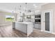 Modern kitchen featuring stainless steel appliances, a center island, and contemporary lighting fixtures at 2041 Greenbriar Ter, Davenport, FL 33837