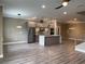 Open-concept kitchen featuring stainless steel appliances and a center island at 2041 Greenbriar Ter, Davenport, FL 33837
