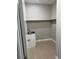 Small laundry room featuring a sink, a utility cabinet, and overhead shelving at 2041 Greenbriar Ter, Davenport, FL 33837