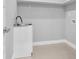 Laundry room with sink, white cabinet, and tiled floors at 2041 Greenbriar Ter, Davenport, FL 33837