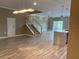 Living area with staircase and stylish light fixture and hardwood flooring at 2041 Greenbriar Ter, Davenport, FL 33837