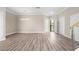 Bright living room with modern lighting, light beige walls, and wood-look flooring at 2041 Greenbriar Ter, Davenport, FL 33837