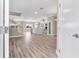 Spacious and bright living room boasts wood floors, an open staircase, and modern finishes at 2041 Greenbriar Ter, Davenport, FL 33837