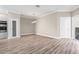 Open-concept living room with wood-look floors and a stainless steel built-in oven at 2041 Greenbriar Ter, Davenport, FL 33837